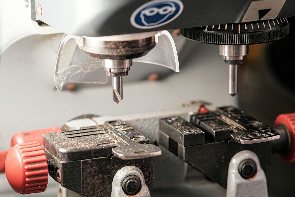 A Close Up of a Machine That is Cutting a Key — South Coast Locksmiths in Fairy Meadow, NSW