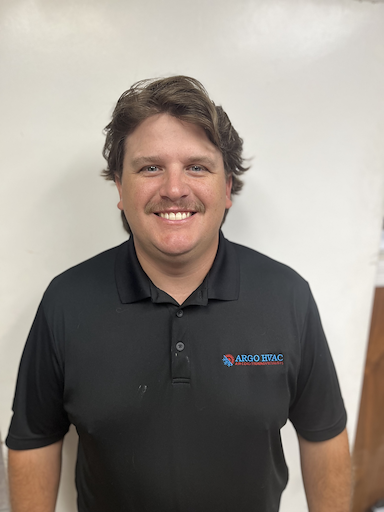 Man in black polo shirt smiling at the camera, wearing a logo that says ARGO ESAC.