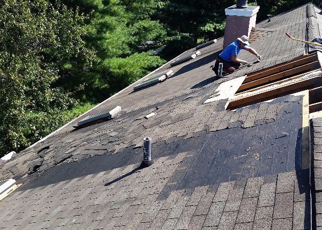 man working on a roof replacement project