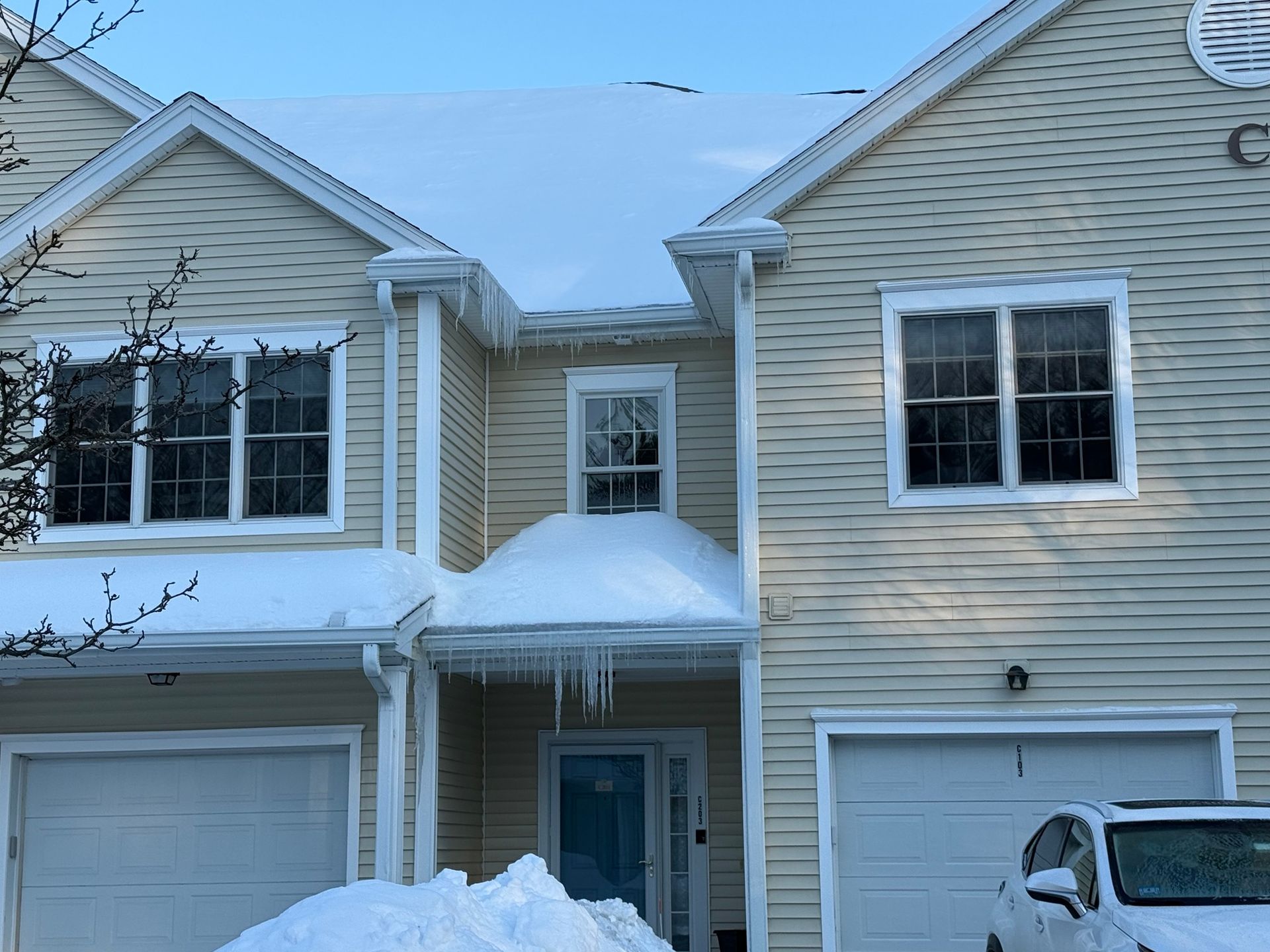 Townhouses with snow and ice on roof