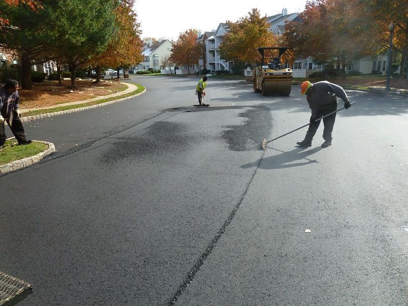 Workers paving a residential roadway