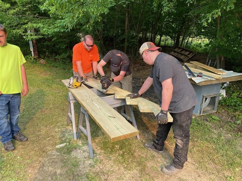 Workers cutting wood