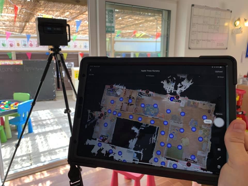 A person is holding a tablet with a map on it.