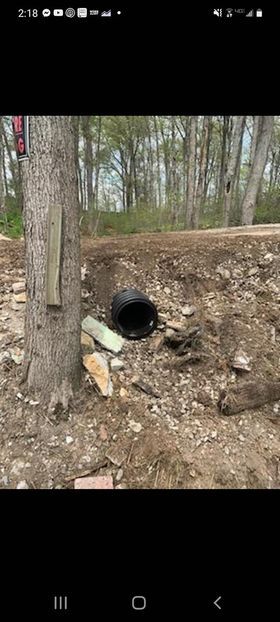 Dark black pipe sticking out of the ground next to a tree - Campbellsburg, IN | Twisted Electric LLC 
