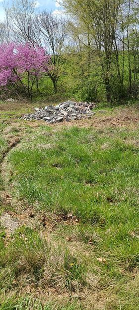 Pile of rocks in the middle of a healthy grassy field - Campbellsburg, IN | Twisted Electric LLC 