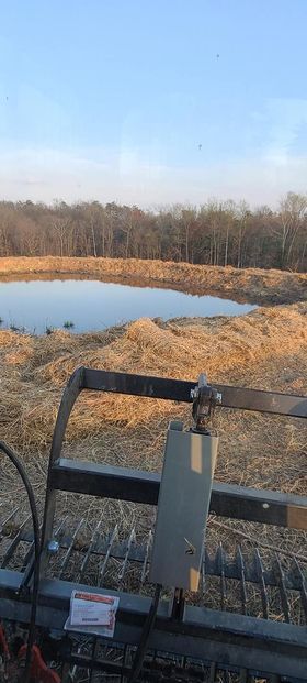 Tractor working on a field next to a pond - Campbellsburg, IN | Twisted Electric LLC 