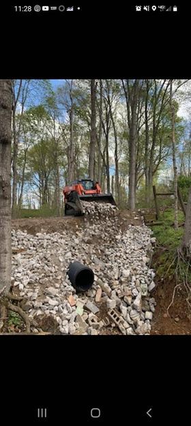 Bulldozer working on a pile of rocks in the woods - Campbellsburg, IN | Twisted Electric LLC 