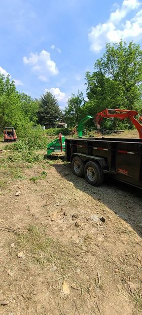 Dump truck parked in a dirt lot next to a tree chipper - Campbellsburg, IN | Twisted Electric LLC 