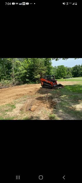 Small bulldozer in the middle of a dirt field with tree shadow casting on it  - Campbellsburg, IN | Twisted Electric LLC 