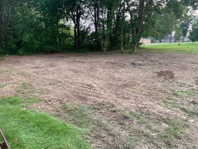 Dirt field with shade trees on the background - Campbellsburg, IN | Twisted Electric LLC 