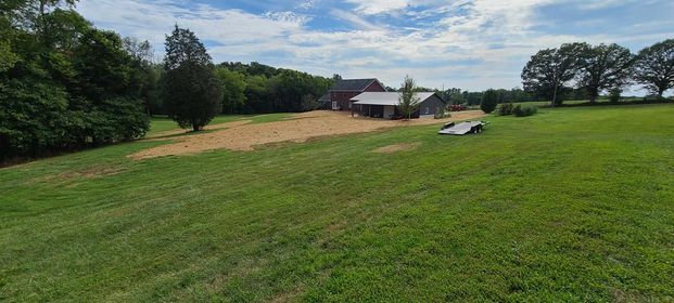 Peaceful large lush green field with a house in the background - Campbellsburg, IN | Twisted Electric LLC 