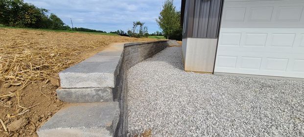 Concrete retaining wall is being built next to a garage door - Campbellsburg, IN | Twisted Electric LLC 