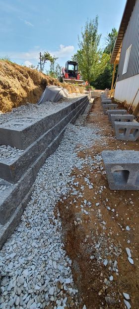 Concrete retaining wall is being built next to a house - Campbellsburg, IN | Twisted Electric LLC 