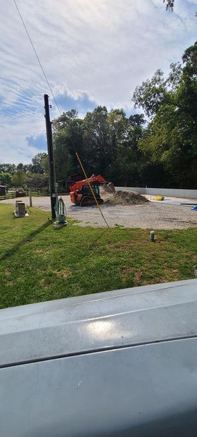 Bulldozer digging a hole in the dirt in a parking lot - Campbellsburg, IN | Twisted Electric LLC 