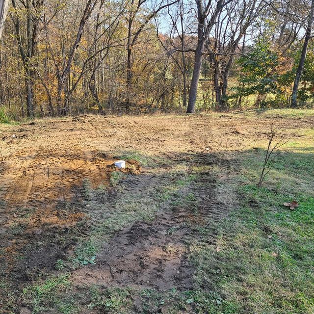Dirt field in the middle of a forest with white item on the middle - Campbellsburg, IN | Twisted Electric LLC 