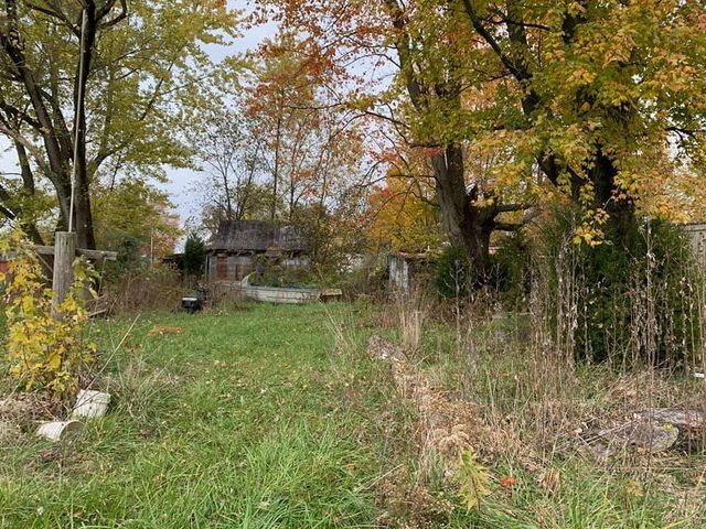 Old shed in the middle of a field with trees in the background - Campbellsburg, IN | Twisted Electric LLC 