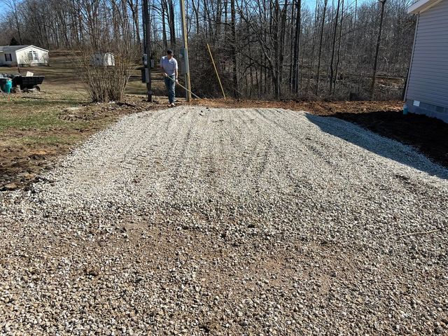 Man raking gravel backyard - Campbellsburg, IN | Twisted Electric LLC 