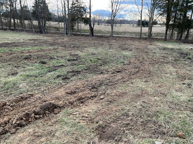 Dirt field with a lot of tracks in it and trees in the background - Campbellsburg, IN | Twisted Electric LLC 