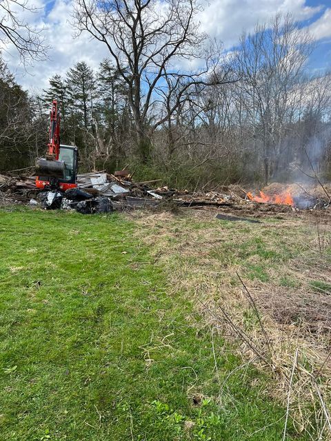 Bulldozer sitting in the middle of a field next to a fire - Campbellsburg, IN | Twisted Electric LLC 