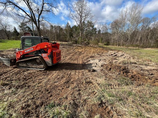 Half red excavator driving through a dirt field - Campbellsburg, IN | Twisted Electric LLC 