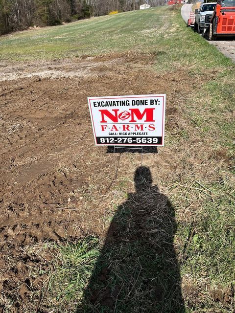 Sign that says excavating done by nem farms is in the middle of a field - Campbellsburg, IN | Twisted Electric LLC 