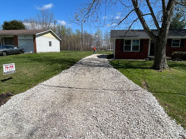 Gravel driveway leading to a red brick house - Campbellsburg, IN | Twisted Electric LLC 
