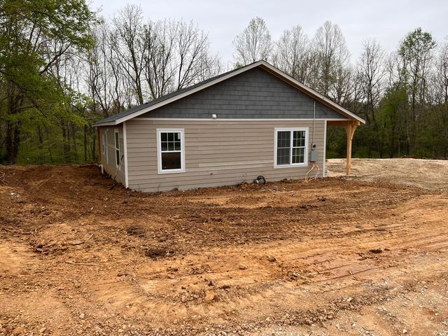 Small house sitting on top of a dirt hill in the middle of a forest - Campbellsburg, IN | Twisted Electric LLC 