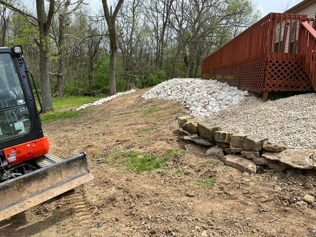 Bulldozer sitting in the dirt next to a pile of rocks in front of a house - Campbellsburg, IN | Twisted Electric LLC 