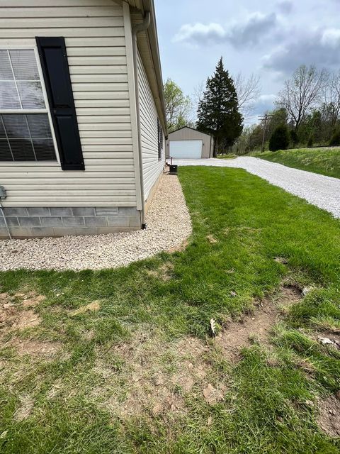 Mobile home sitting next to a gravel driveway with garage - Campbellsburg, IN | Twisted Electric LLC 
