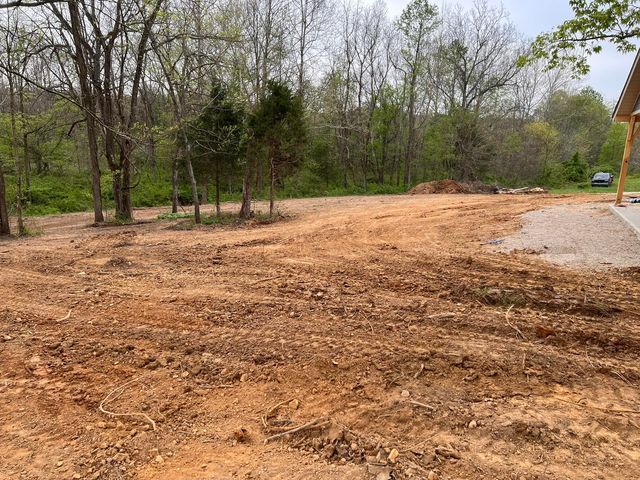 Large soil field with trees in the background and a house in the background - Campbellsburg, IN | Twisted Electric LLC 