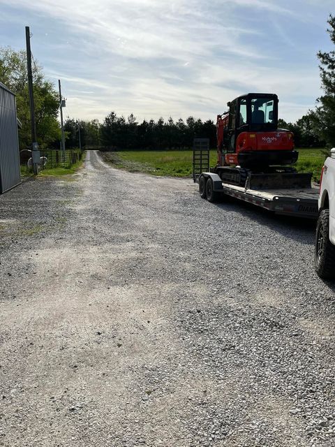 Excavator sitting on top of a trailer in a gravel road - Campbellsburg, IN | Twisted Electric LLC 