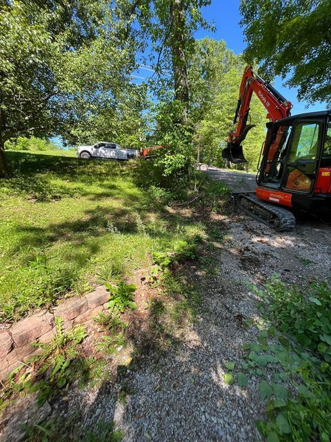 Orange and black excavator facing car - Campbellsburg, IN | Twisted Electric LLC 