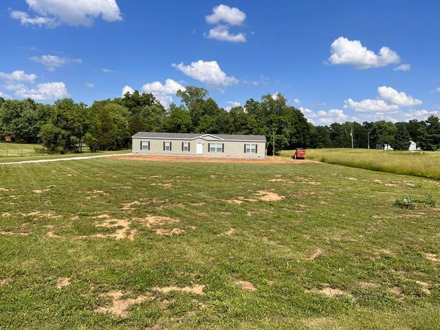 Mobile home sitting in the middle of a wide grassy field - Campbellsburg, IN | Twisted Electric LLC 