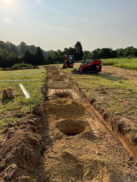 Two bulldozers digging holes in the dirt in a field - Campbellsburg, IN | Twisted Electric LLC 