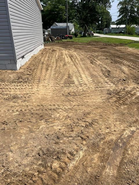 Dirt lot in front of a house with a house in the background - Campbellsburg, IN | Twisted Electric LLC 