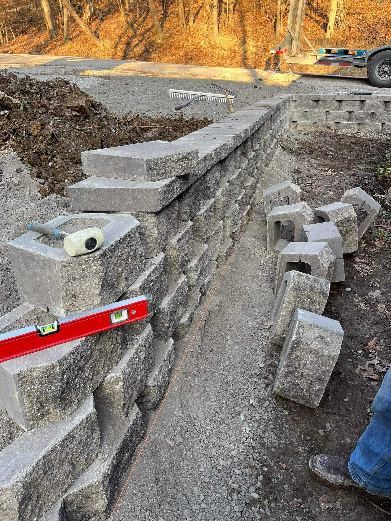 A person is using a level to check the level of a brick wall.