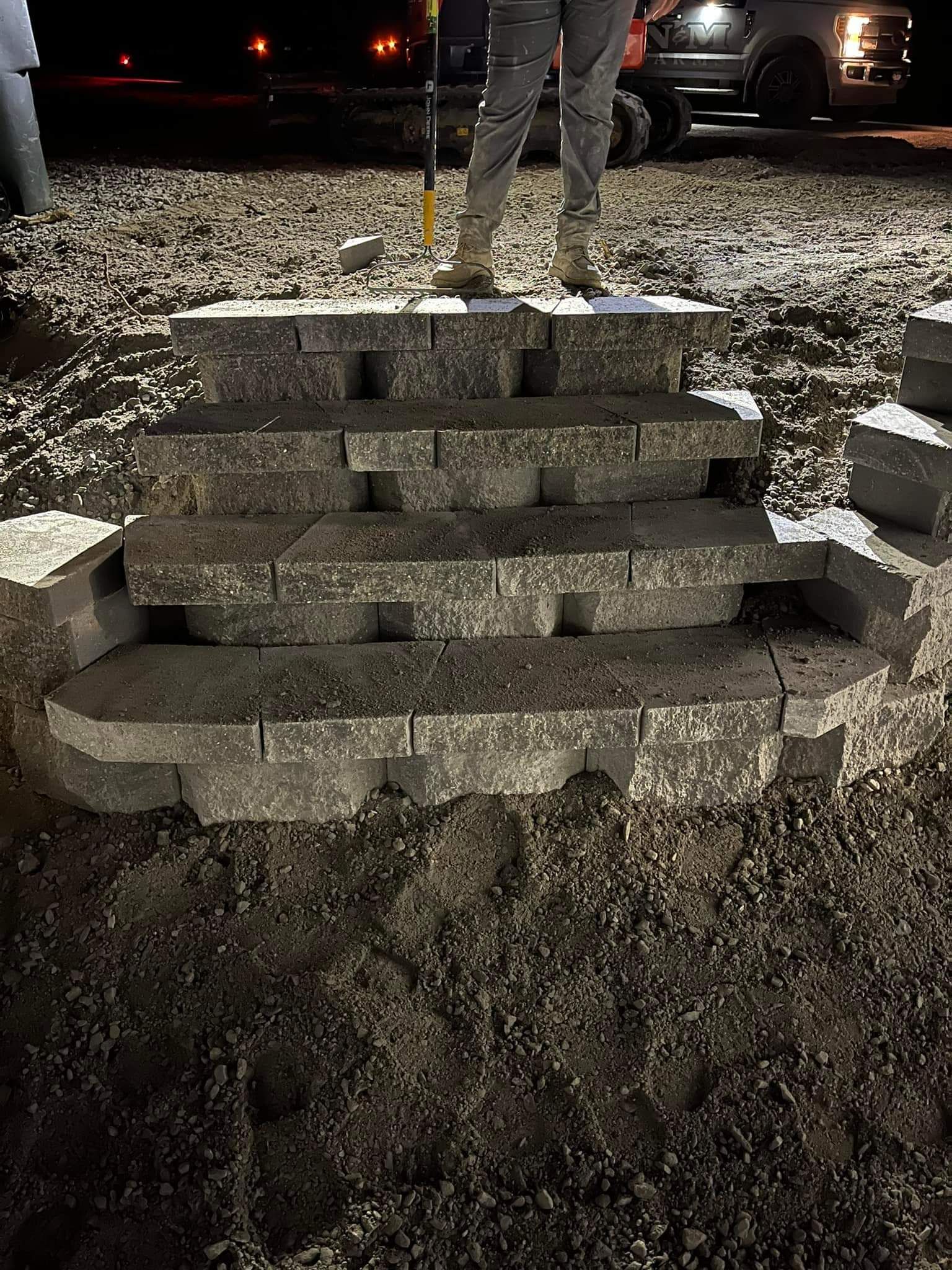 A person is standing on top of a pile of bricks.