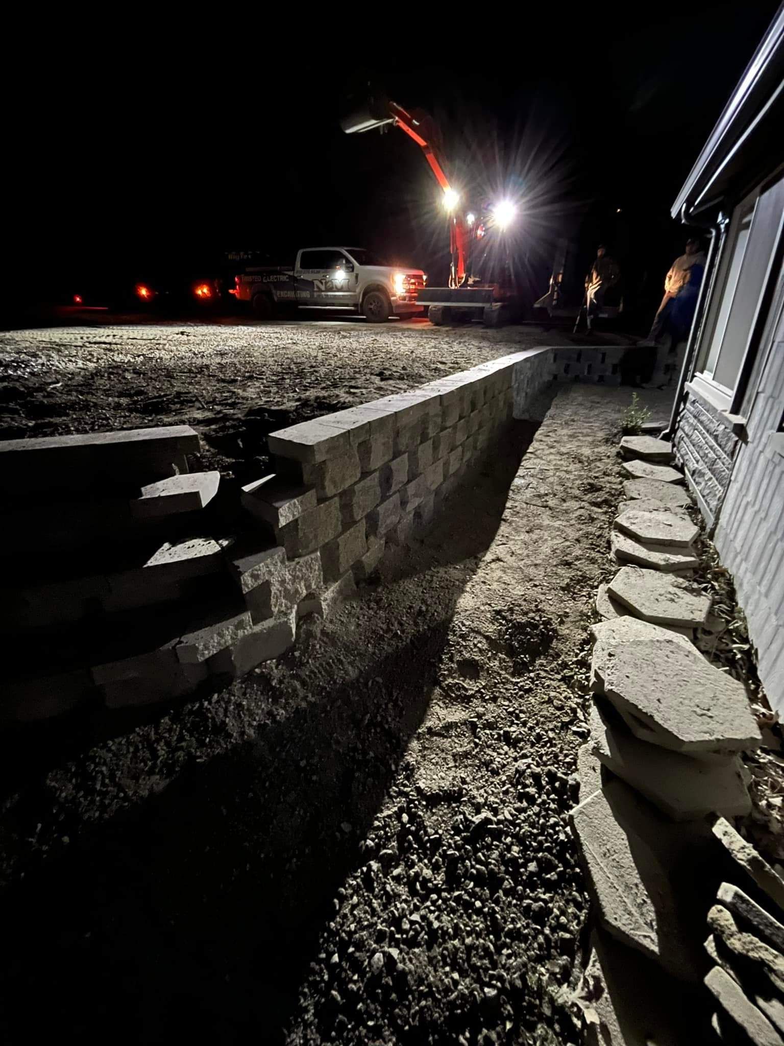 A truck is parked in front of a house at night.
