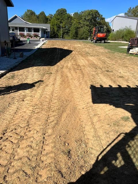 Dirt road leading to a house with a bulldozer in the background - Campbellsburg, IN | Twisted Electric LLC 