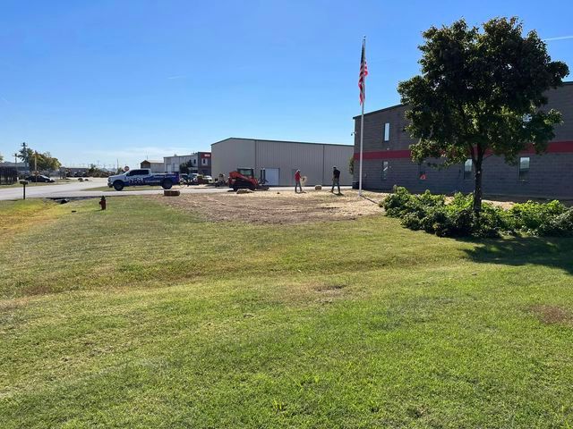 Large lawn in front of a building with a flag pole in the middle of it - Campbellsburg, IN | Twisted Electric LLC 