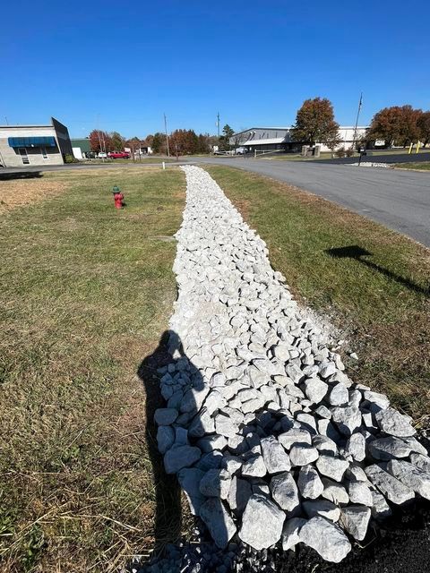 Worker shadow casted on grass and gravel - Campbellsburg, IN | Twisted Electric LLC 