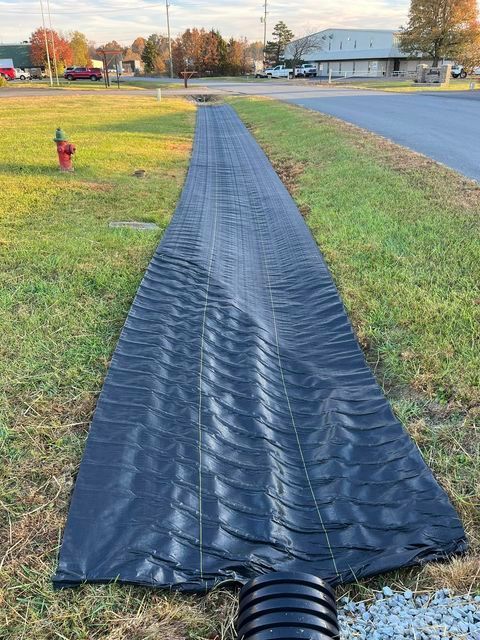 Black tarp laying on the grass next to a fire hydrant - Campbellsburg, IN | Twisted Electric LLC 