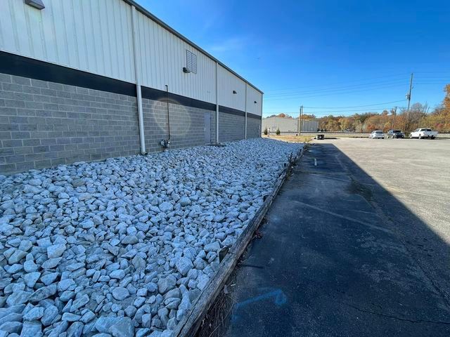 Large pile of rocks sitting in front of a brick building with shadow - Campbellsburg, IN | Twisted Electric LLC 
