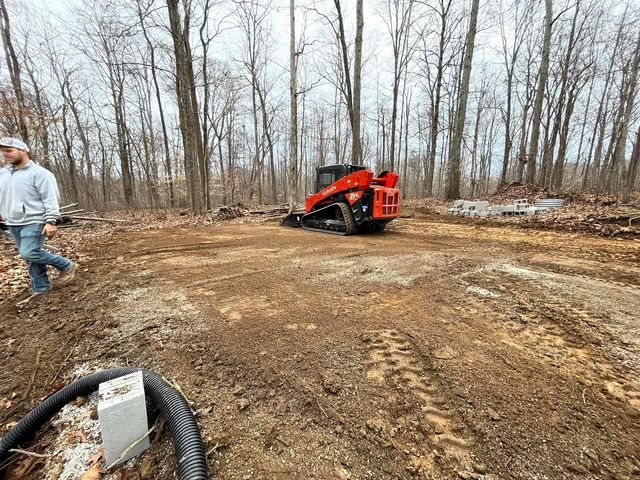 Man walking down a dirt road next to a bulldozer in the woods - Campbellsburg, IN | Twisted Electric LLC 