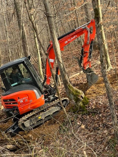 Red and black kubota excavator stuck in the woods - Campbellsburg, IN | Twisted Electric LLC 