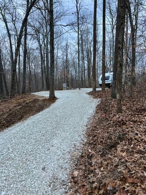 White van parked on the side of a gravel road in the woods - Campbellsburg, IN | Twisted Electric LLC 