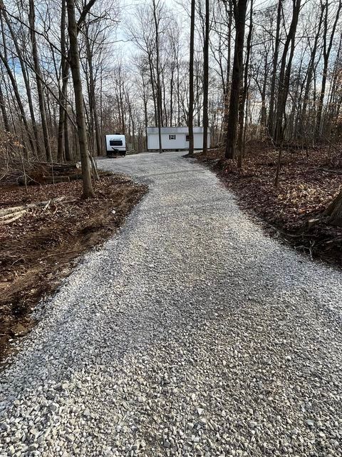Gravel driveway leading to a house in the woods with dead trees - Campbellsburg, IN | Twisted Electric LLC 