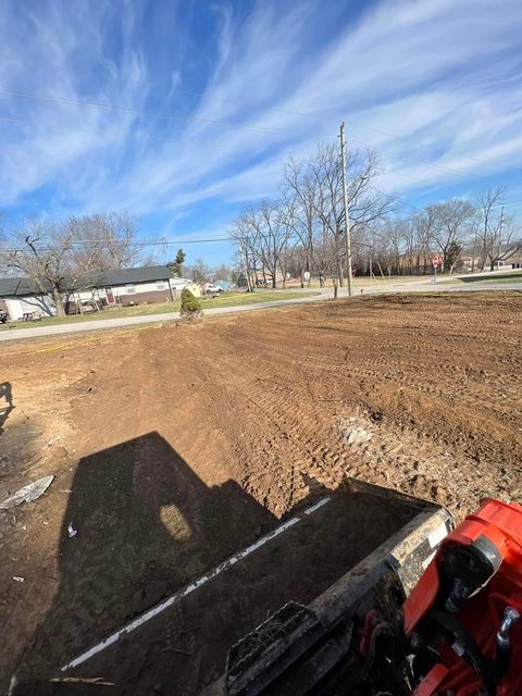 Man driving a bulldozer through a clear dirt field - Campbellsburg, IN | Twisted Electric LLC 