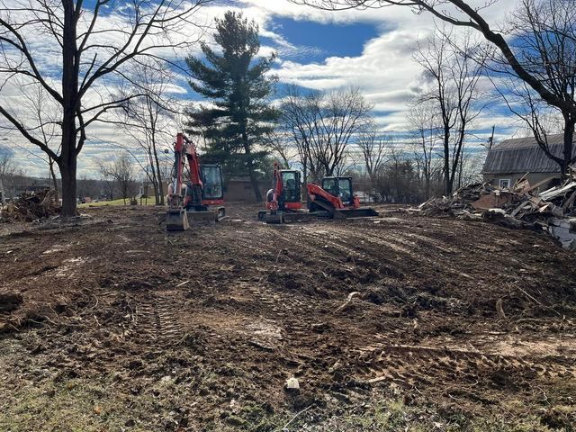 Two excavators working on a dirt field with dead tree - Campbellsburg, IN | Twisted Electric LLC 