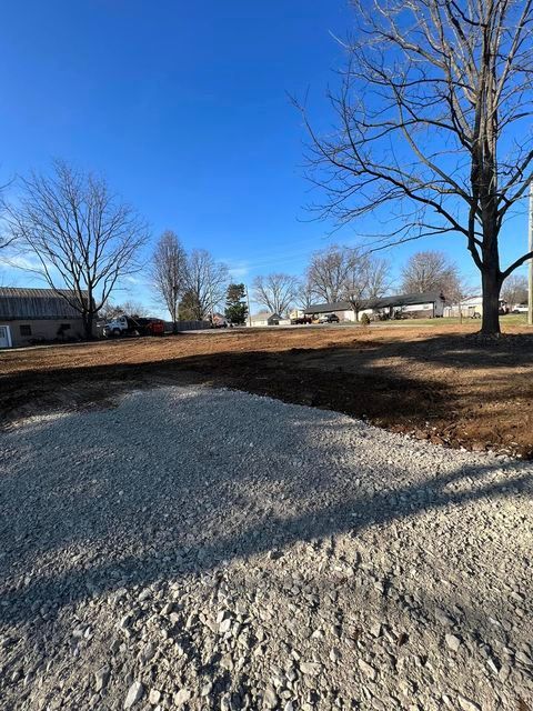 Dirt lot with a tree in the middle of it and a blue sky in the background - Campbellsburg, IN | Twisted Electric LLC 